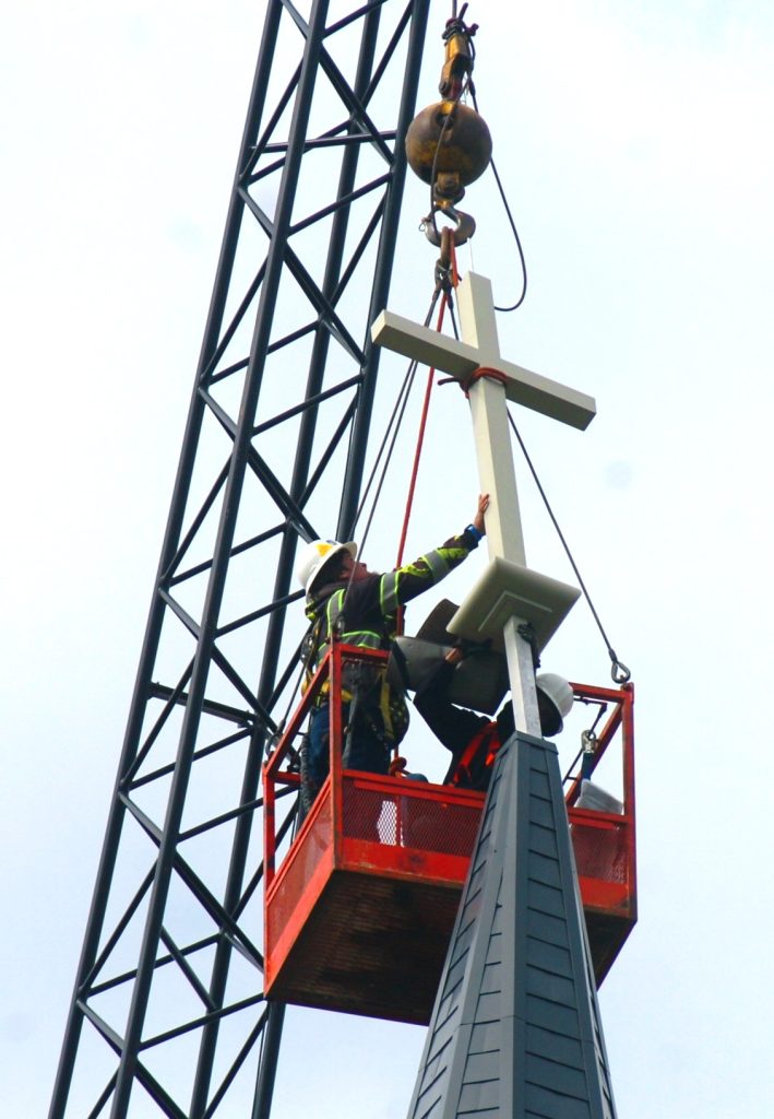 The new cross was the last piece to be added over St. Patrick's Church in Janesville. JNR photo by Dan Plutchak